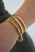 Evy - bandarmband Goud aan pols